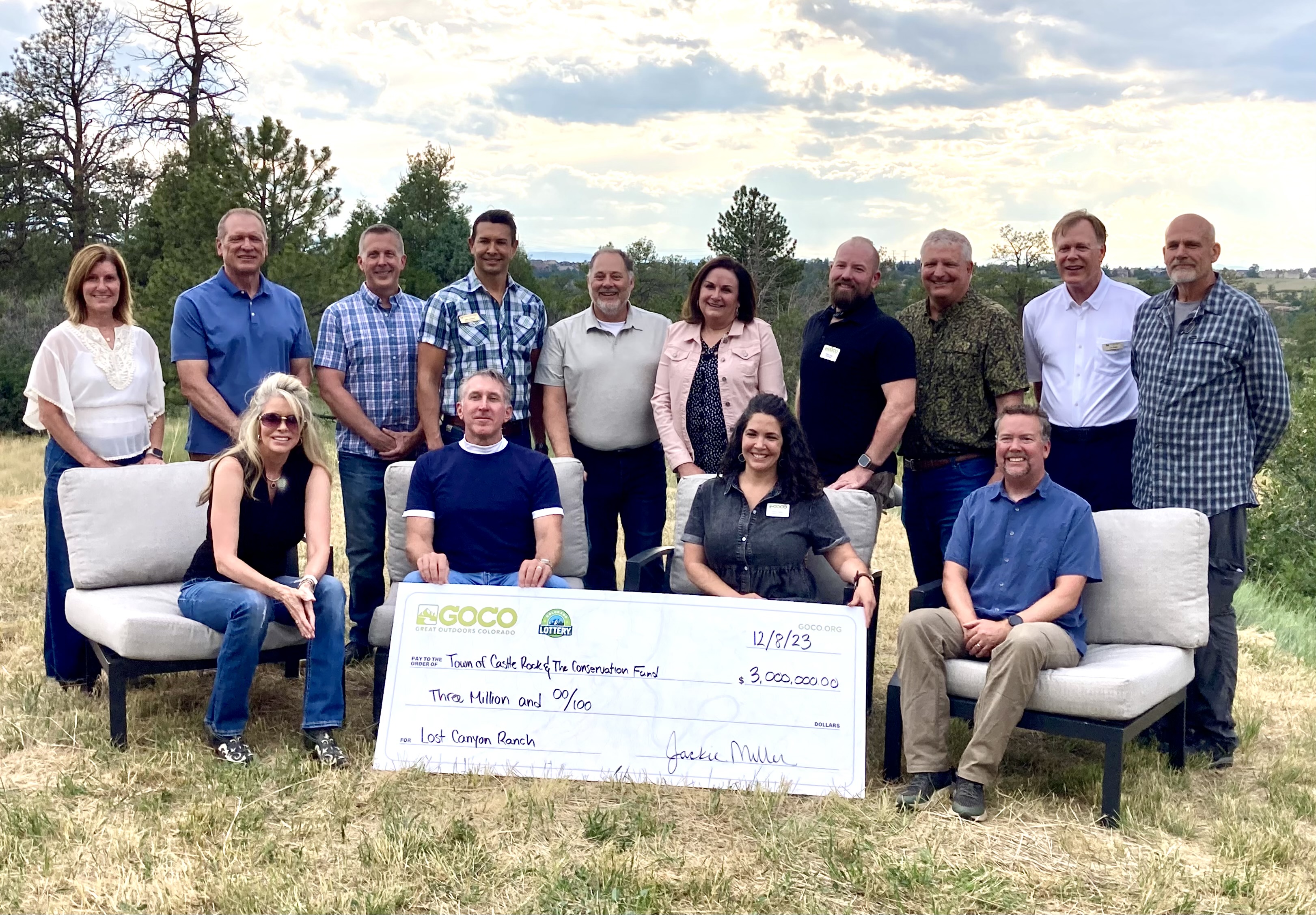 Tim Dietz holding a ceremonial check for the Lost Canyon open space preservation effort