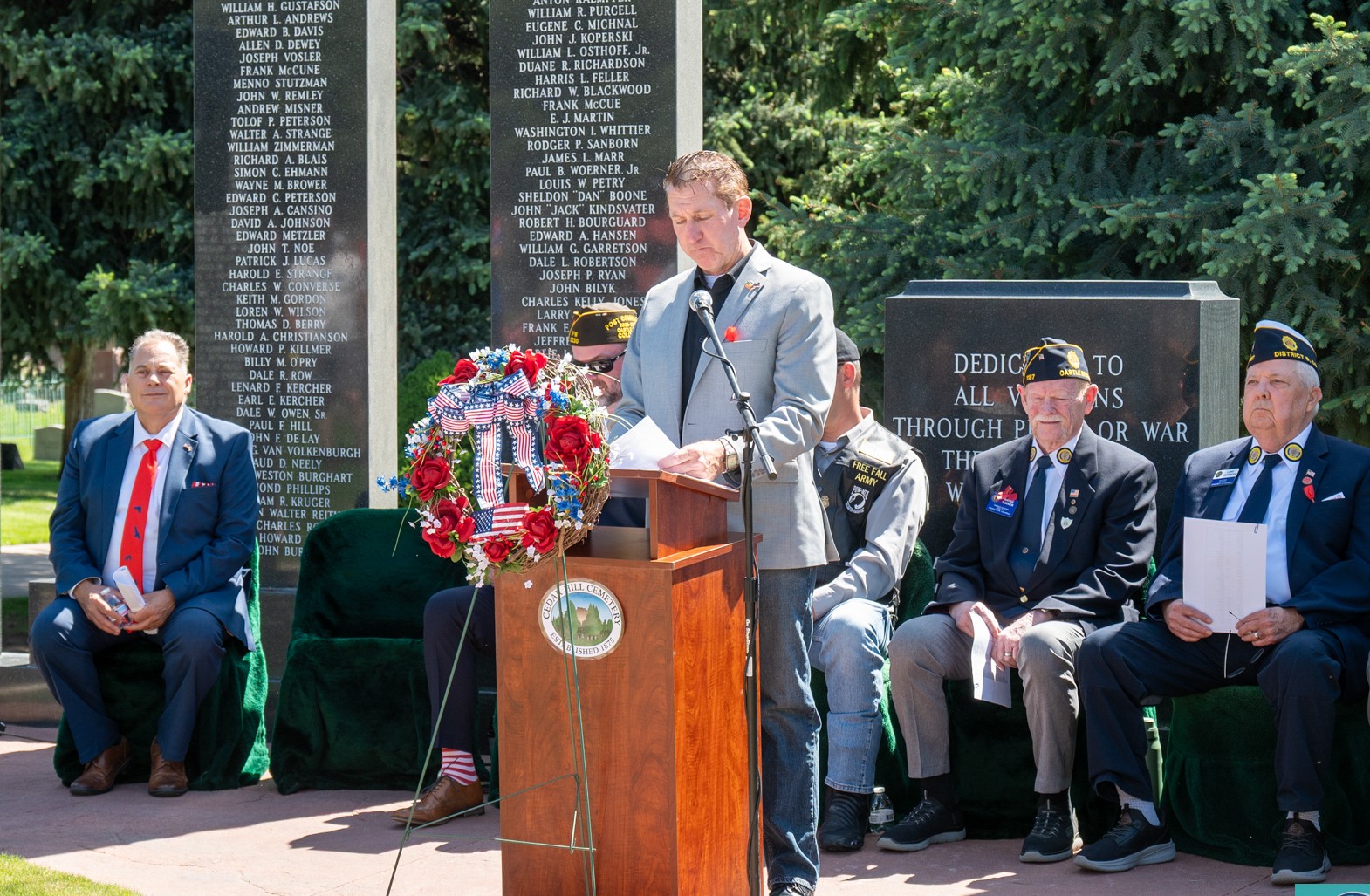 Tim Dietz reading names aloud at the Veterans Memorial during Castle Rock's 2026 Memorial Day ceremony at Cedar Hill Cemetery